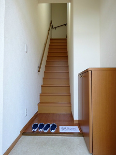玄関からすぐ階段。訪問者に生活環を見せずにお迎えできます。